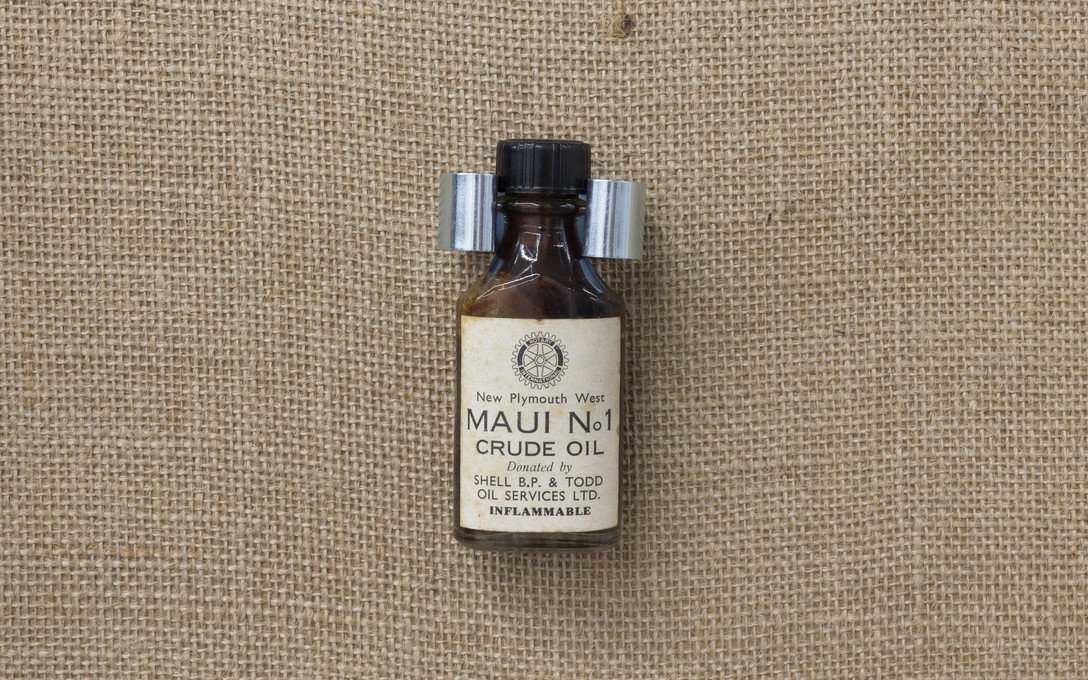 Fiona Clark, Gaslands and The Waitara Project, Maui Crude Oil, 1963. Bottle by New Plymouth West Rotary Club. Detail view. Courtesy of Cheska Brown.